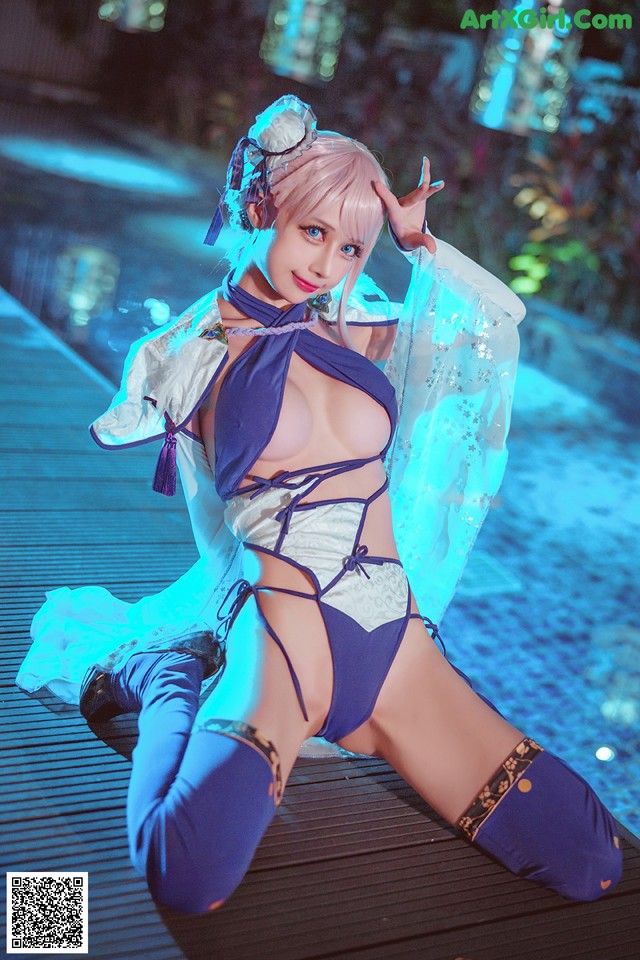 A woman in a blue and white outfit posing for a picture.