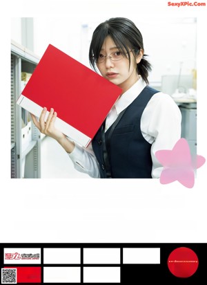 A woman in a school uniform holding a red folder.