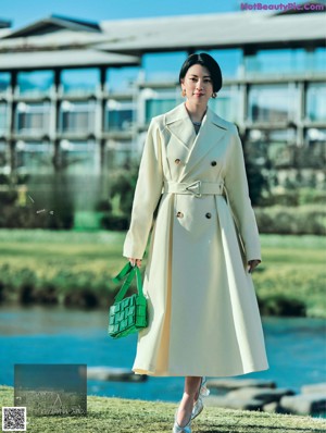 A woman in a black dress is shown in a magazine.