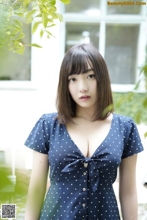 A woman in a blue bikini and a colorful kimono.