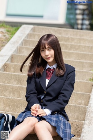 A woman in a school uniform is crossing the street.
