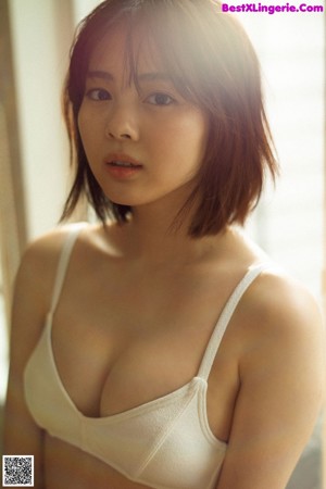 A woman in a pink bra and panties posing for a picture.