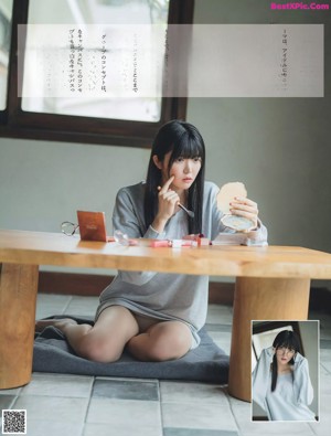 A woman laying on a tatami mat in a white bra.