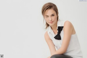 A woman in a black dress posing for a picture.