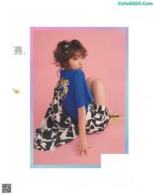 A woman in a white shirt and shorts posing for a magazine.