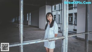 A woman sitting on top of a concrete wall.