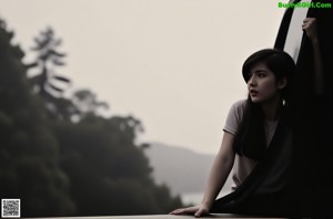 A woman with long black hair looking up at the sky.