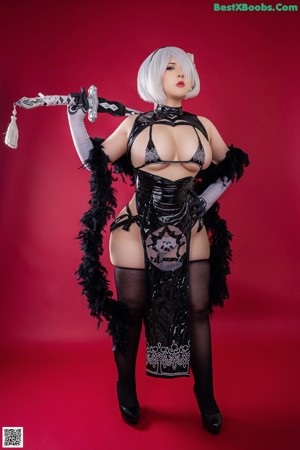 A woman in a bikini holding a sword.