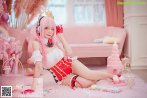 A woman in a bunny costume holding a lollipop.