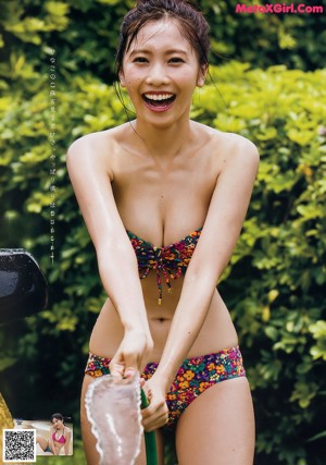A woman in a red bikini in the water.