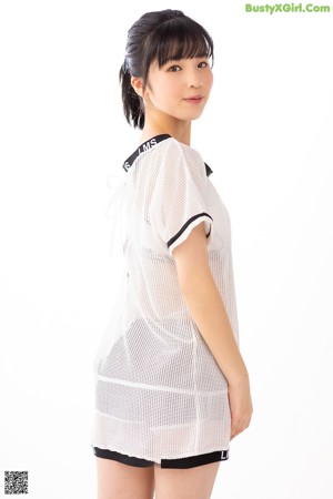 A young woman wearing a white shirt with a number 10 on it.