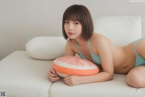 A woman in a pink and white striped bikini posing for a picture.