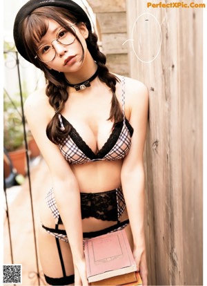 A woman in a white bra and panties is posing for a magazine.