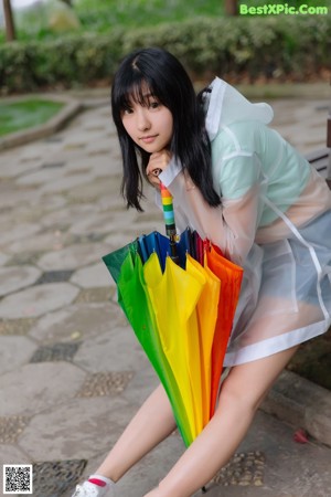 A woman in a white shirt and skirt holding an umbrella.