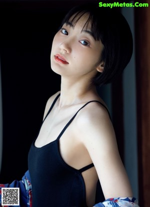 A woman sitting on a couch with her legs crossed.